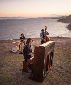 Brekky Boy band performing on a clifftop by the ocean