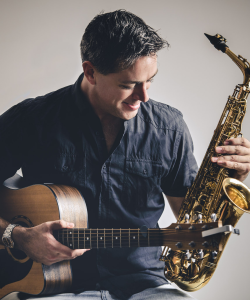 Chris Gable with acoustic guitar and saxophone