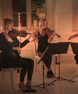Greenhill Strings quartet playing violins by candlelight