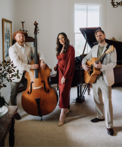 Duke Music trio with double bass, acoustic guitar and vocalist beside a piano