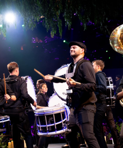 Dynasty Showband drummers performing at a night event