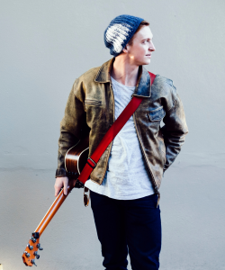 Linden Furnell, Sydney singer-guitarist, in a beanie with electric guitar