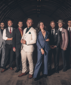 Tequila Mockingbird band members in suits posing together