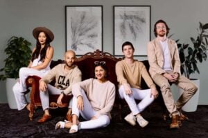 Kaleidoscope Dream band members posing on a couch