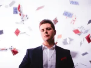 Roving magician with playing cards flying through the air