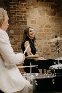 Keyboardist from The Systems smiling beside the drummer